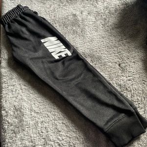 Boys Nike Dri-Fit track pants.